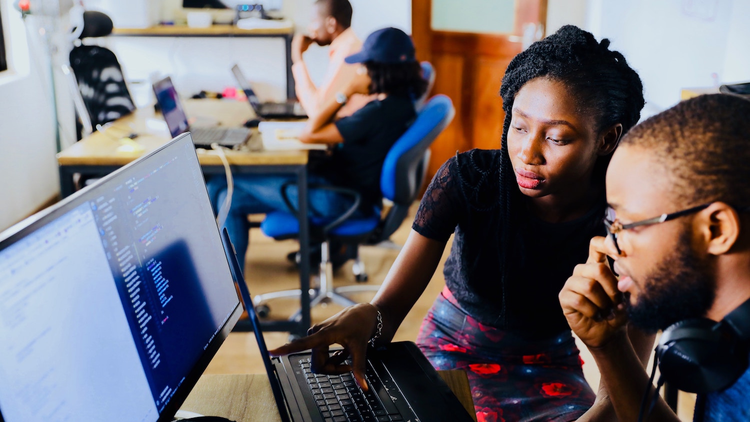 An African American woman and man working together at a computer